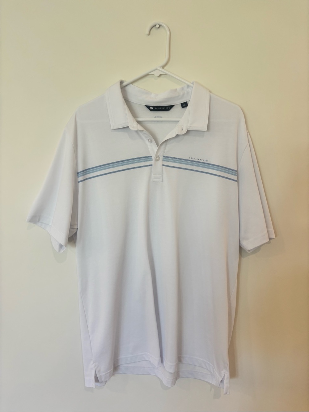 Travis Mathew White Polo with Light Blue Chest Stripes